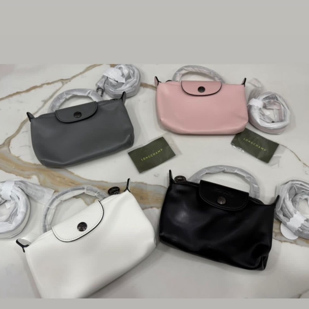Longchamp Clutches in Black, White, Gray, and Pink